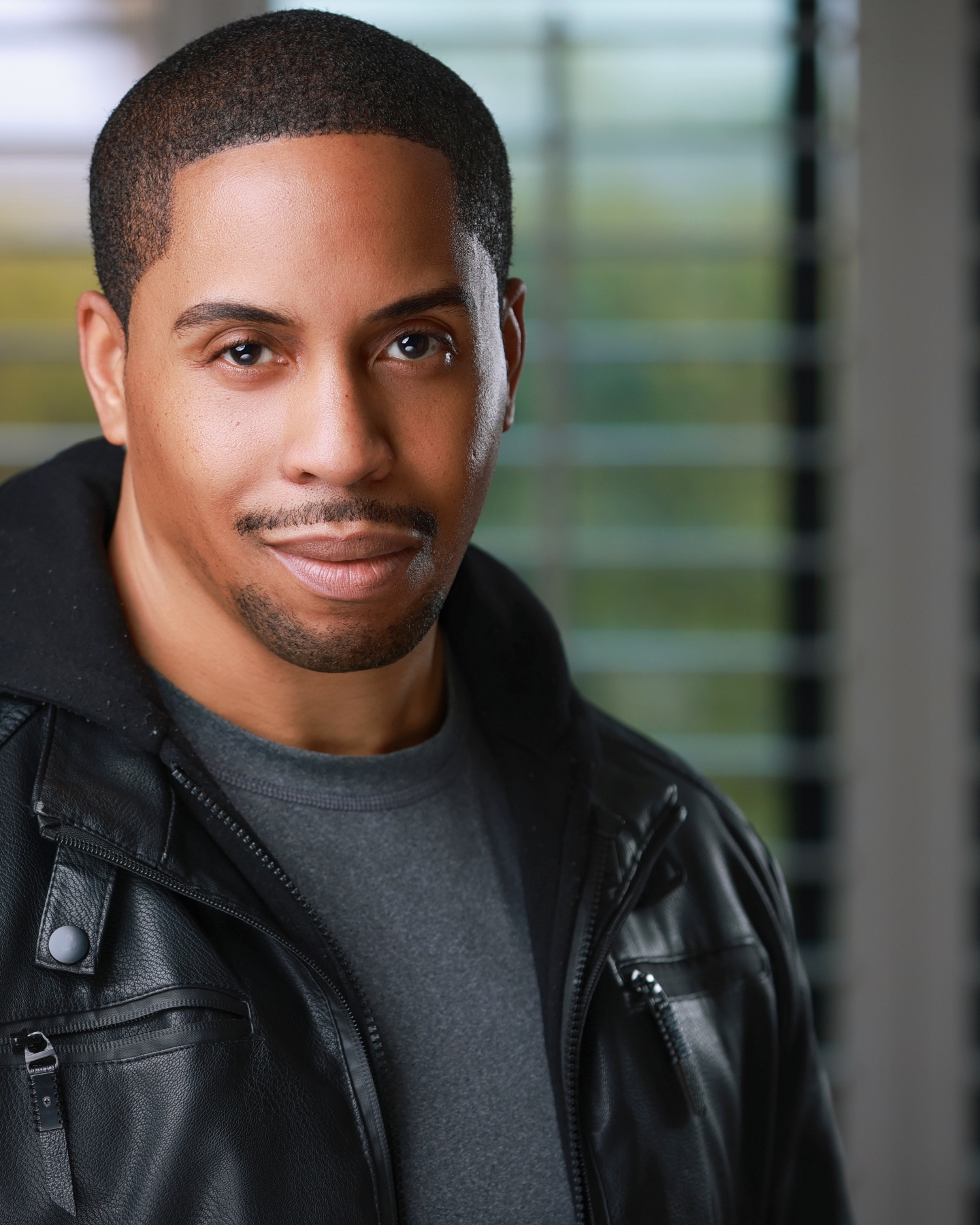 Professional acting headshot of a man in a black leather jacket
