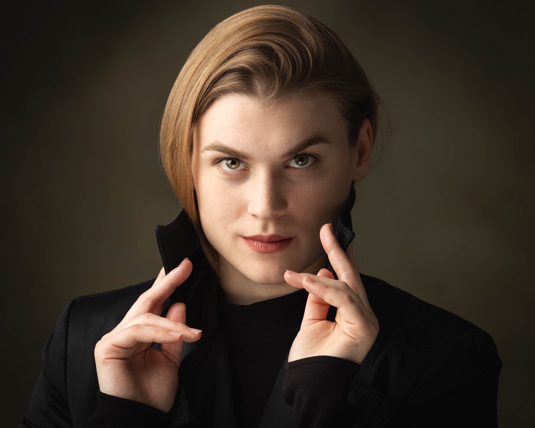 Actor headshot of a woman framed by expressive hands