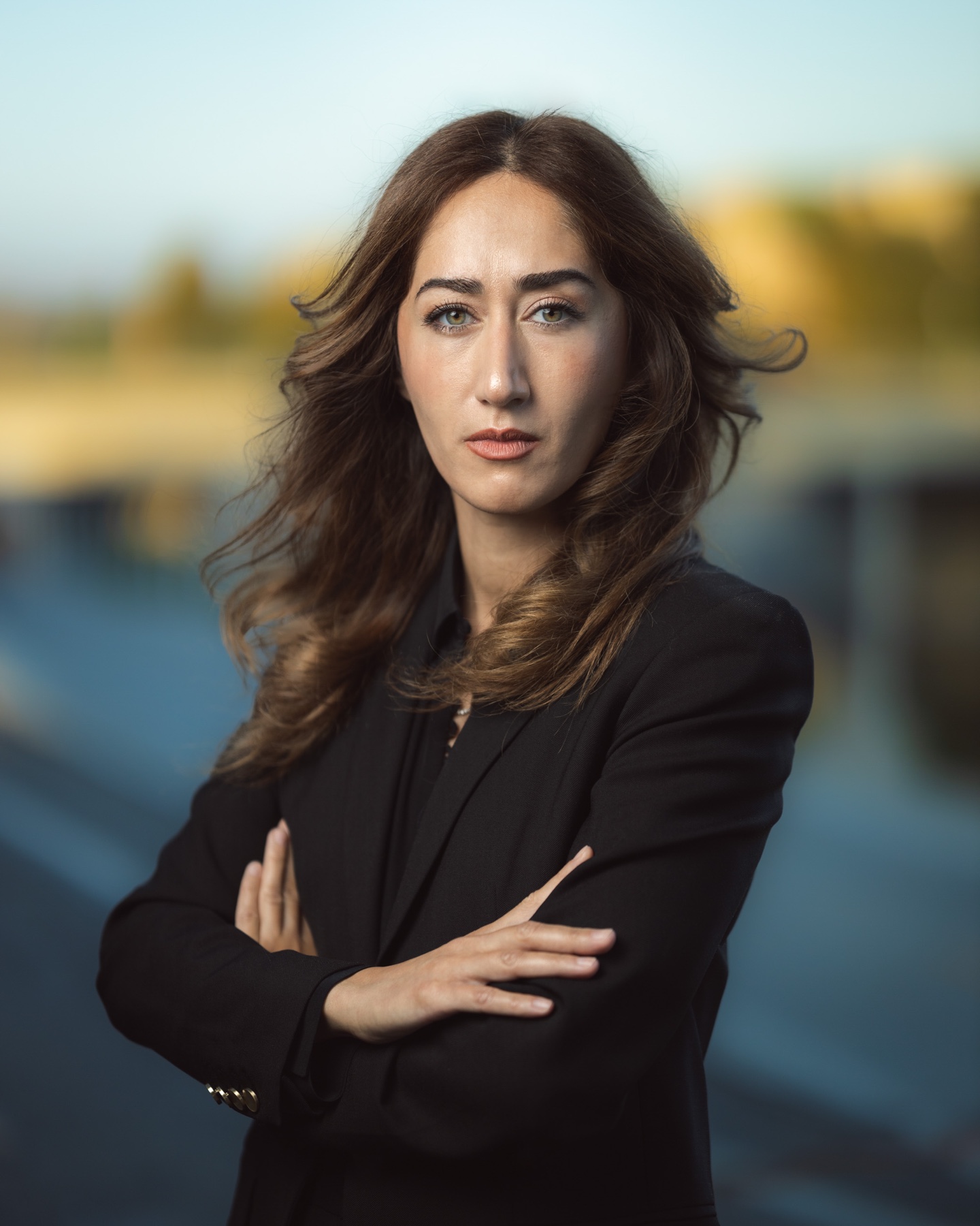 Outdoor corporate portrait of a woman in a black suit