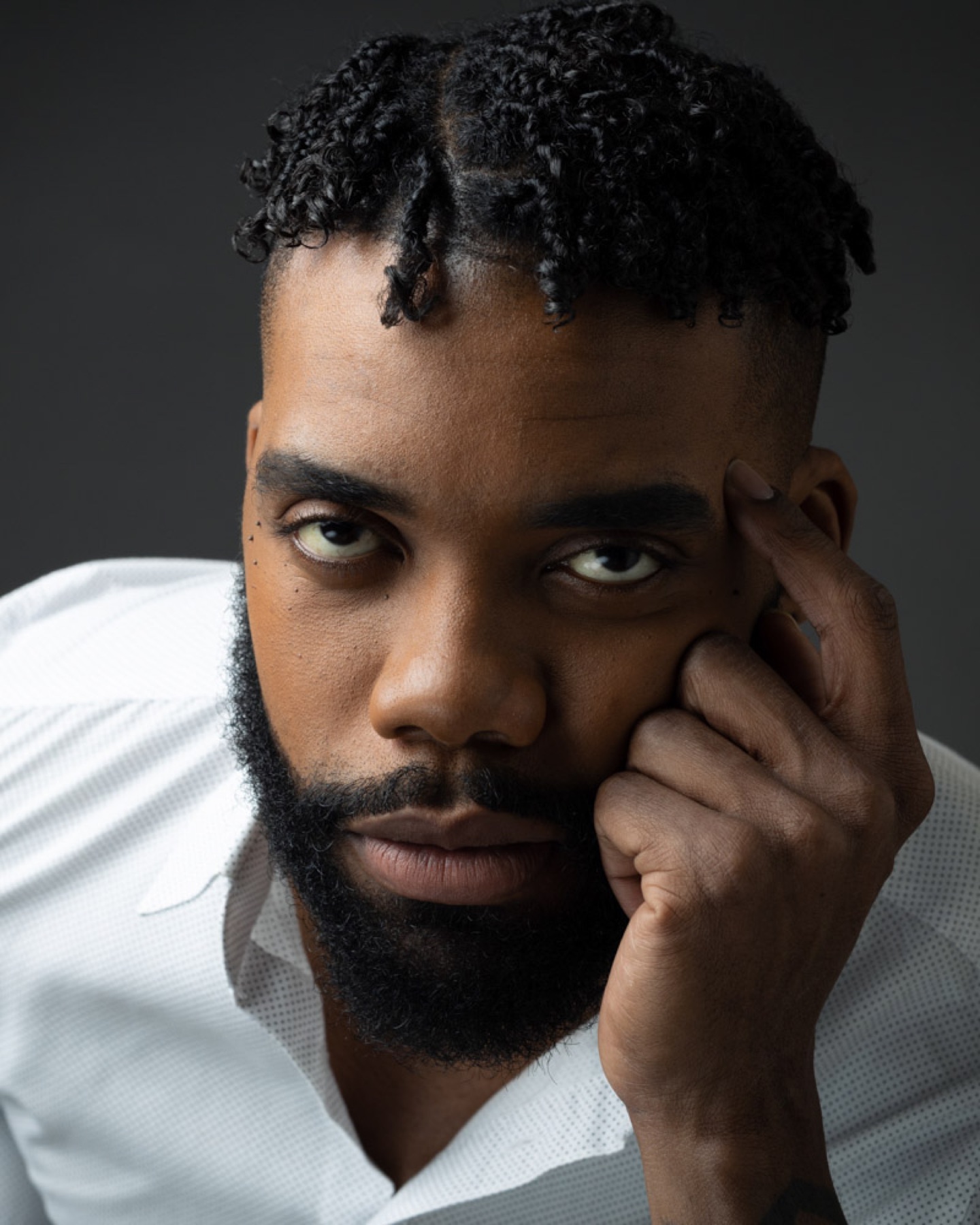 Creative portrait of a bearded man in a white shirt